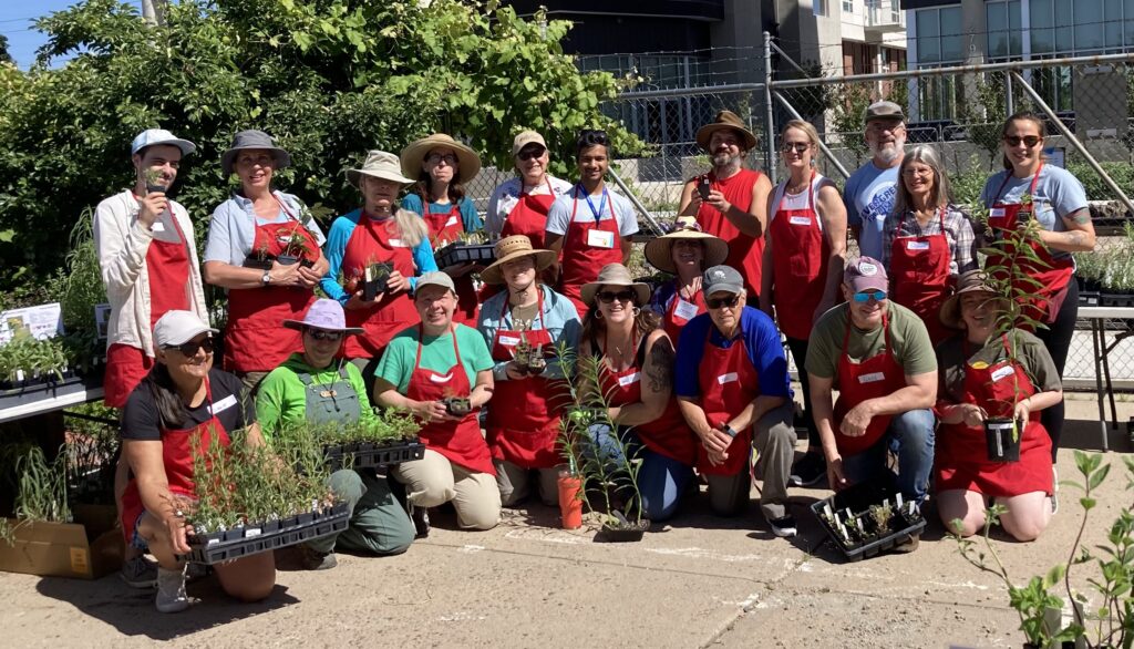 Volunteers hold Colorado native plants at the Denver Plant Swap and Giveaway