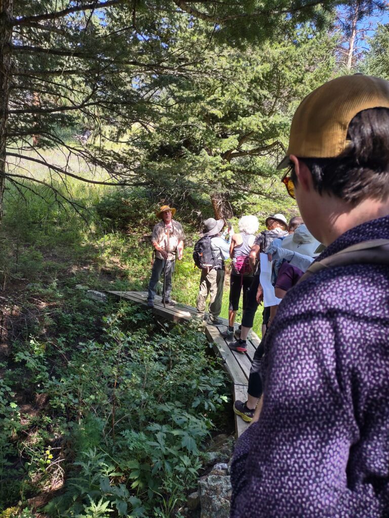 Brian leads the committee across the bridge that links his and Eileen's property to the Roosevelt National Forest